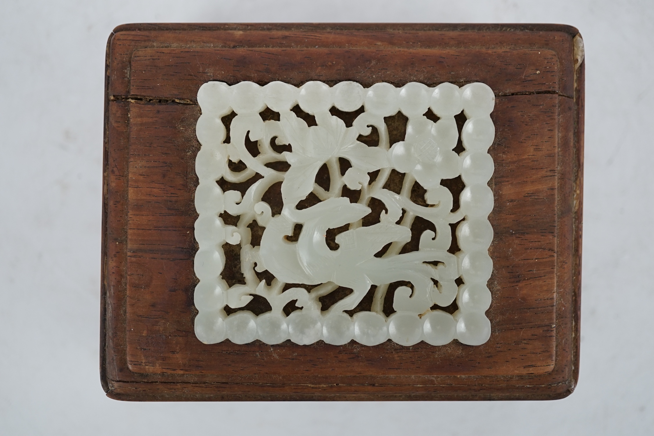 A Chinese pale celadon jade plaque, 17th/18th century, now inset into a hongmu box